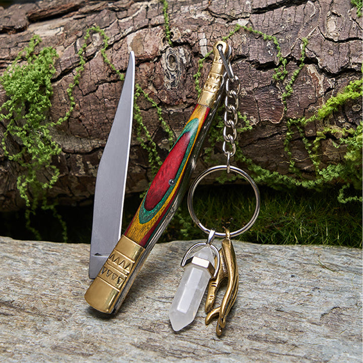 Coltello pieghevole da esterno con manico colorato e collana con mano di Buddha in cristallo bianco - image 1