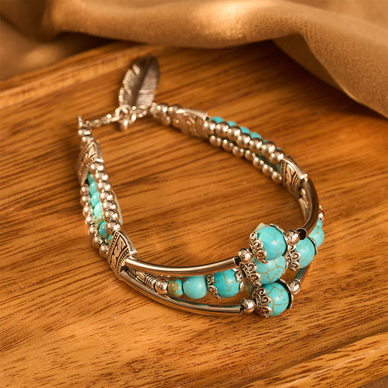 Bracciale vintage boho a triplo strato con piume turchesi e argento anticato - image 1